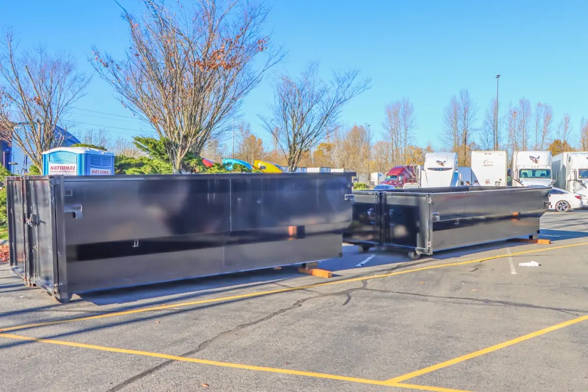 Professional dumpster rental service with roll-off container on residential driveway in Rockland